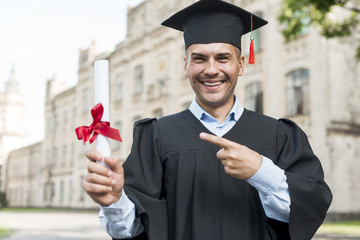 Wall Mural - Graduation concept with portrait of happy man