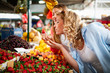 © NDABCREATIVITY - Young women friends baying vegetables and fruits on the market