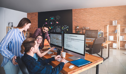 Team of programmers working in office