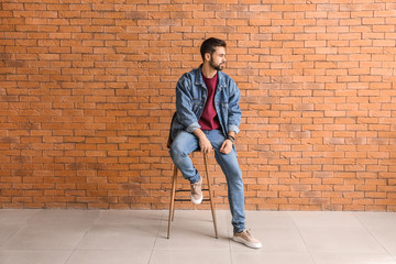 Poster - Fashionable young man near brick wall