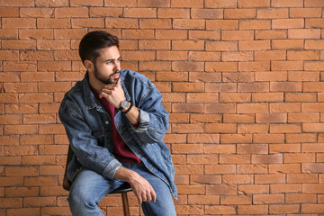 Wall Mural - Fashionable young man near brick wall