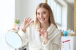 © Pixel-Shot - Beautiful woman flossing teeth at home
