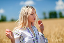 Beautiful Girl In Traditional Costume In A Wheat Field
