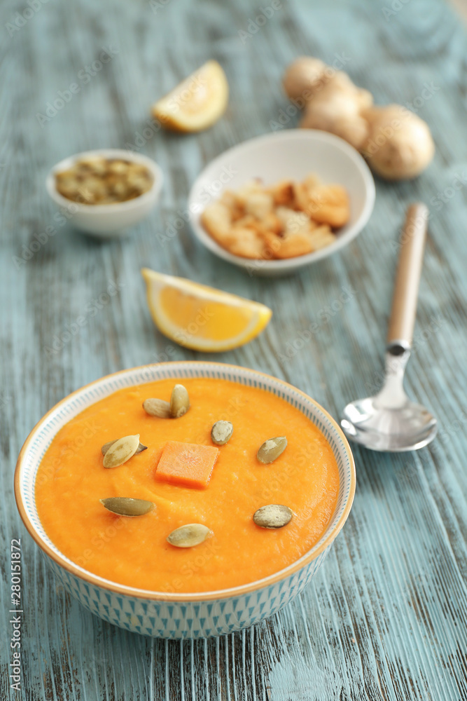 Bowl of tasty cream soup on table