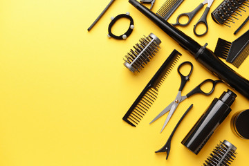 Set of hairdresser tools and accessories on color background