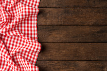 Red Checkered Tablecloth On Wooden Background