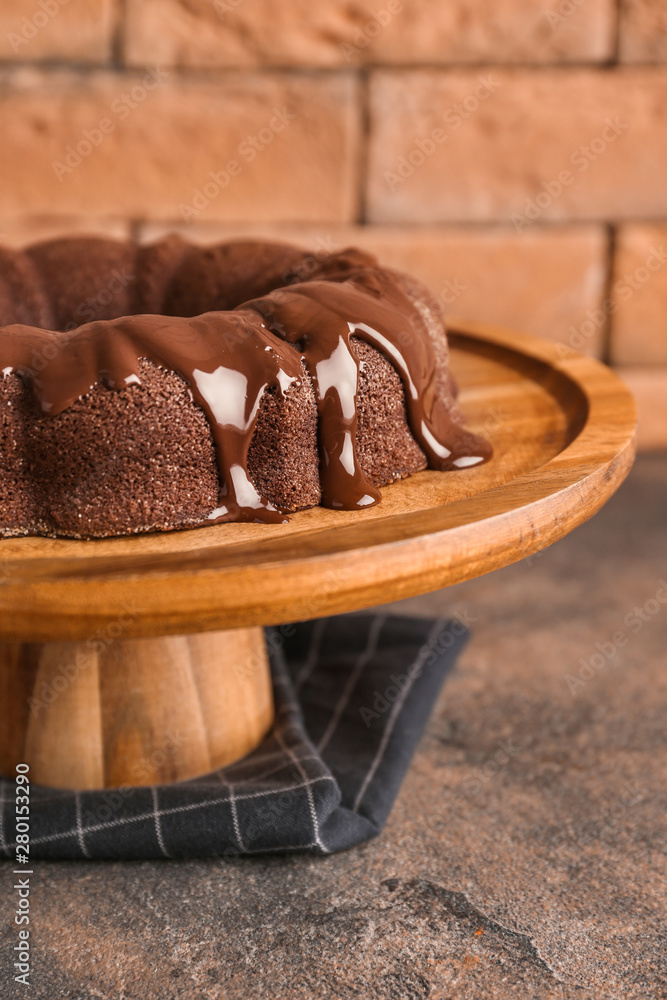 Dessert stand with tasty chocolate cake on table