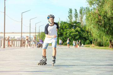 Wall Mural - Teenage boy on roller skates outdoors