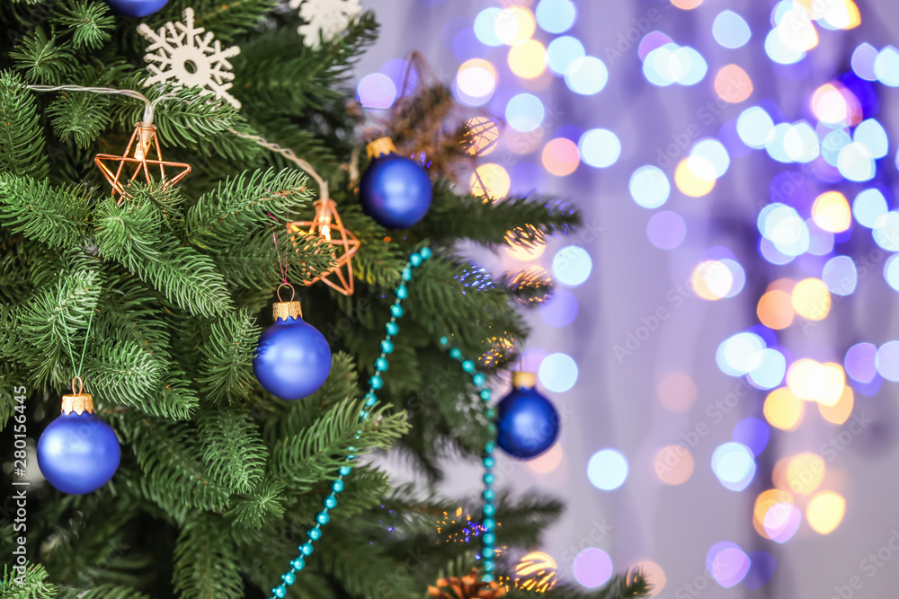 Beautiful Christmas tree against defocused lights, closeup