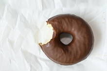 Chocolate Donut On White Wrinkled Paper