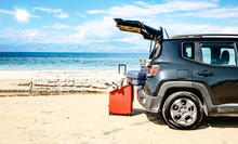 A Summer Car With Some Luggage On A Sandy Beach And Ocean View