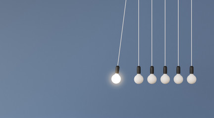 mock up of hanging light bulbs with one glowing on blue wall background,conceptual idea of pendulum,