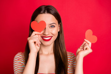 Wall Mural - Close-up photo portrait of pretty nice optimistic she her lady holding two little hearts hiding closing covering eyes isolated bright background