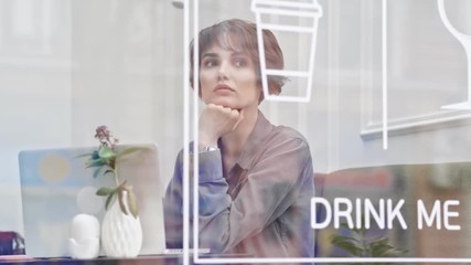 Sticker - Young attractive pensive woman using laptop sitting in the cafe