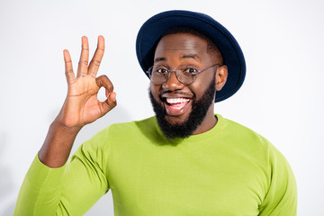 Wall Mural - Portrait of funky person showing ok sign advertising promotion wearing green sweater isolated over white background