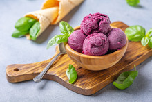 Blueberry Ice Cream Balls And Green Basil In A Wooden Bowl.