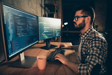 Wall Mural - Close up side profile photo handsome he him his guy brainstorming briefing coder typing php css keyboard development outsource IT two monitors table office agency wear specs formalwear plaid shirt