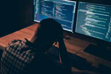 Close up back rear behind photo handsome he him his guy stress work day night coder html keyboard development outsource IT processing language monitors table office wear specs formalwear plaid shirt