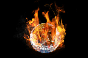 global warming and pollution concept : fire burning planet earth globe isolated on black background.