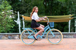 young woman with bicycle in the park