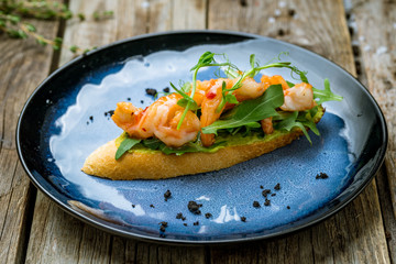 Wall Mural - Bruschetta with prawns and guacamole on plate