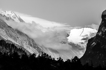 Wall Mural - Black and white view of misty mountains. Morning in Himalayas, Nepal, Annapurna conservation area