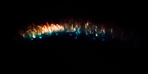 Wall Mural - iridescent holographic rainbow background. colorful lens flare bokeh texture on black