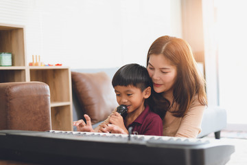 Wall Mural - image of happy family at living room,happiness time of family playing at home,Mom and baby are happiness coexistence,happy family concept and Creating activities to strengthen skills for children.