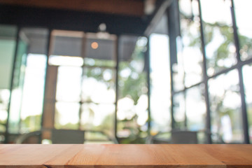 Wall Mural - Wooden table with Blurred of coffee's shop for abstract background