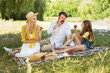 © Prostock-studio - Happy family having picnic and eating apples in park
