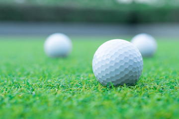 a group of golf ball on green grass