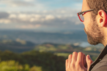 Christian worship and praise. A young man is praying and worshiping in the evening.