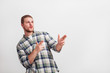 © BigBlueStudio - Portrait of handsome young man pointing finger to an empty copy space