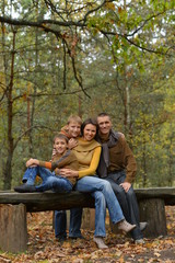 Poster - Portrait of family of four in park