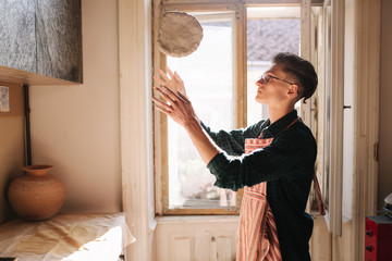 Male potter works with clay. Hand's of man creating ceramic product