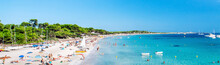 Panoramic Image People Swimming And Sunbathing On The Picturesque Las Salinas Beach. Ibiza, Balearic Islands. Spain
