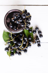 Wall Mural - ripe crop of black currants, delicious berries are on the table.