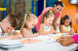 © JackF - Careful children drawing on lesson in class room