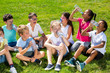 © JackF - Happy children drinking water after running in park outdoors