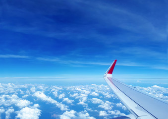 Wing of the airplane flying on the sky