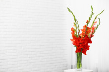 Vase With Beautiful Gladiolus Flowers On Wooden Table Indoors. Space For Text