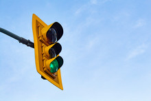 Green Traffic Light Says 'Go' Against A Blue Sky