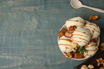 Wall Mural - Flat lay composition with delicious ice cream on wooden table. Space for text