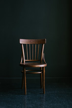 Old-fashioned Wooden Chair On A Dark Background In The Interior
