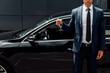 © LIGHTFIELD STUDIOS - cropped view of african american man in suit holding car key