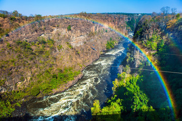 Wall Mural - Beautiful rainbow over the turbulent River