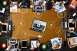© Nuttapong punna - Top view of businessman Group of Multiethnic Busy People meeting with other in modern office with laptop computer, smartphone, tablet, coffee and document on table.