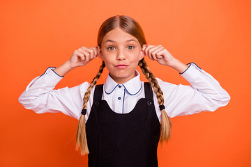 Sticker - Close-up portrait of her she nice attractive lovely winsome charming cute cheerful cheery pre-teen blonde girl holding ears having fun isolated on bright vivid shine orange background