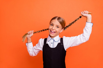 Sticker - Close-up portrait of her she nice attractive lovely careless cheerful cheery pre-teen blonde girl playing with tails having fun isolated on bright vivid shine orange background