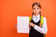 Portrait of her she nice attractive lovely disappointed unlucky pre-teen blonde girl showing bad fiasco mark score first grade isolated on bright vivid shine orange background